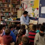 Aaron reads to children at Orr Elementary